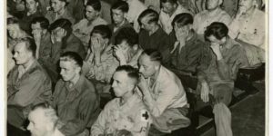 German soldiers in an American prison forced to watch a film of German concentration camp.