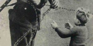 This moment.. An East German soldier ignores orders to let no one pass and helps a boy