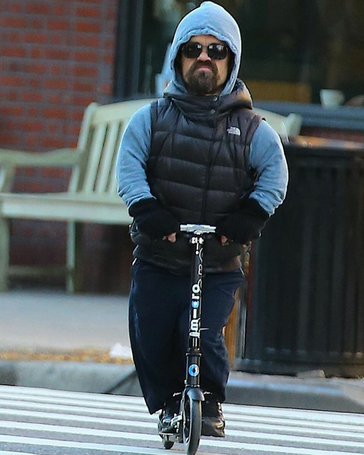 Just Peter Dinklage riding a scooter
