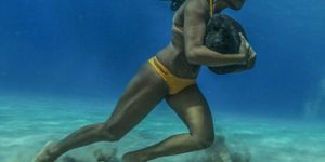 This Hawaiian surfer runs on the ocean floor with a 50 pound boulder, as a way to train to survive the massive surf waves.