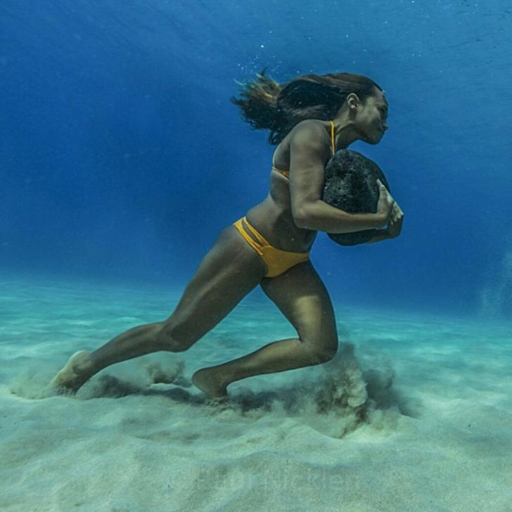 This Hawaiian surfer runs on the ocean floor with a 50 pound boulder, as a way to train to survive the massive surf waves.