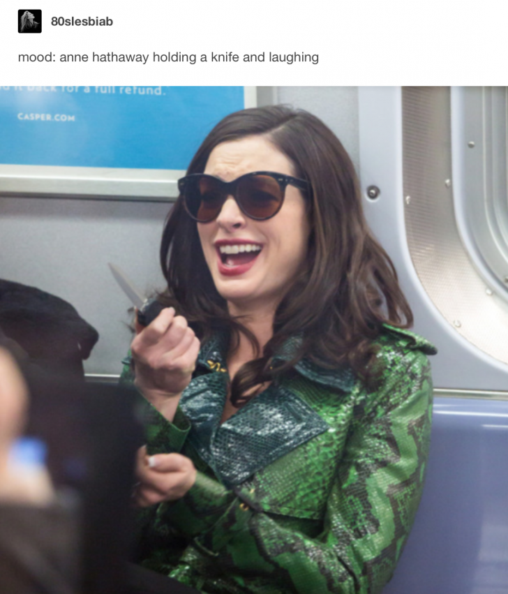 mood: anne hathaway holding a knife and laughing