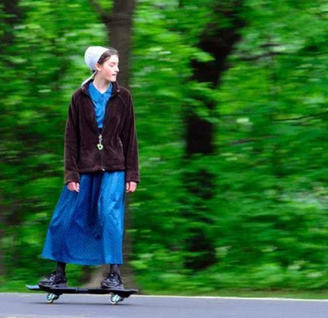 Amish woman skateboarding