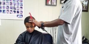 He gives kids a $2 discount if they read a book out loud during their haircut.