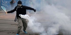 Returning a tear gas canister with a tennis racket