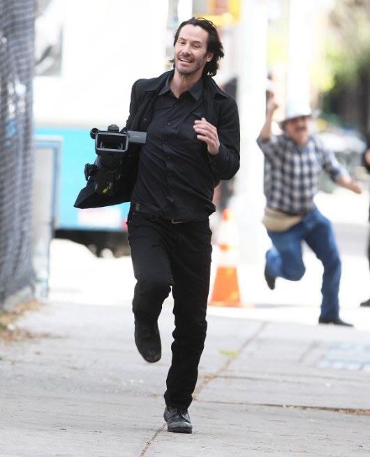 Keanu Reeves stealing a camera from the paparazzi