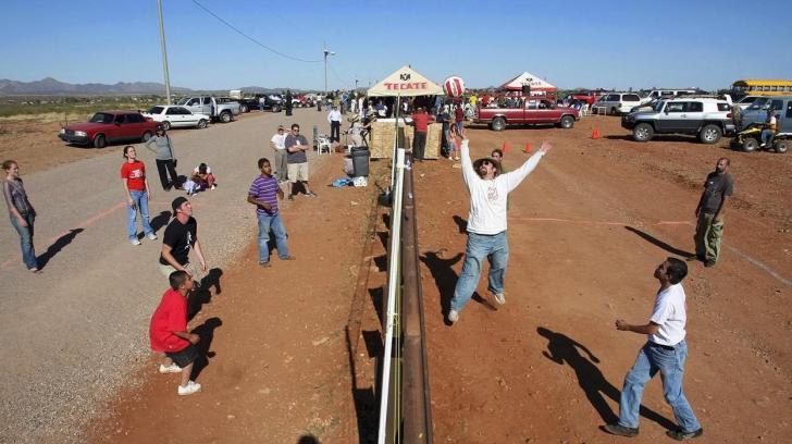 Americans and Mexicans playing volleyball over the US/Mexico border