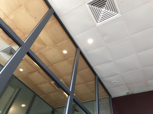 The ceiling tiles in the Da Nang airport smoking section vs. non-smoking section.