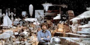 George Lucas surrounded by Star Wars props, 1977