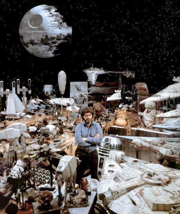 George Lucas surrounded by Star Wars props, 1977