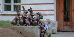 Cute kid trying to help a statue