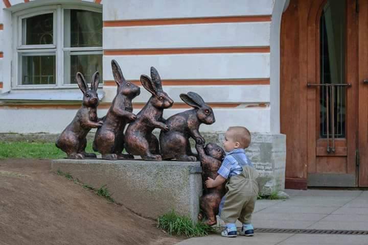 Cute kid trying to help a statue