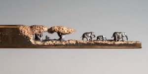 A miniature landscape of elephants carved from the tip of a pencil by Cindy Chinn