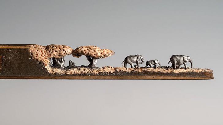 A miniature landscape of elephants carved from the tip of a pencil by Cindy Chinn