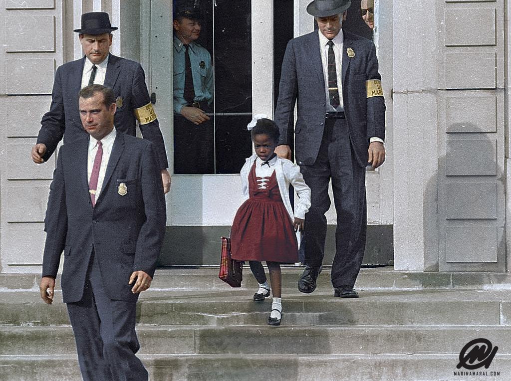 Six year old Ruby Bridges being escorted by U.S. Marshals over fears for her safety. She was one of the first Black children to go to an all White school circa 1960's.