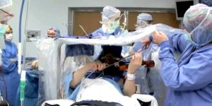 Violinist, Roger Frisch, plays during brain surgery to find what’s causing his tremors.