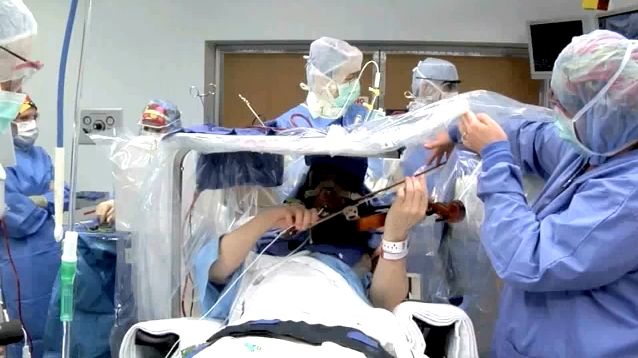 Violinist, Roger Frisch, plays during brain surgery to find what's causing his tremors.