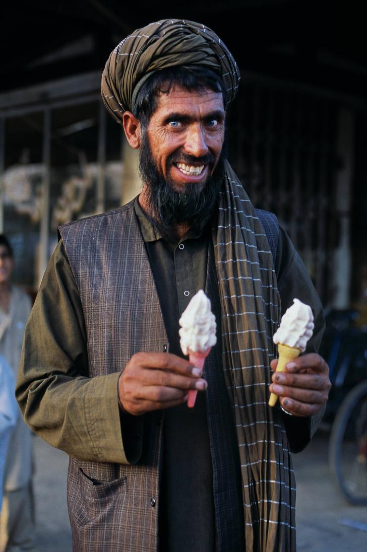 Afghan man holding his ice cream cones, Puli Khumri, Afghanistan.