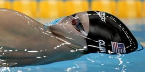 Fantastic shot of Olympic swimmer before breaking the surface tension of water