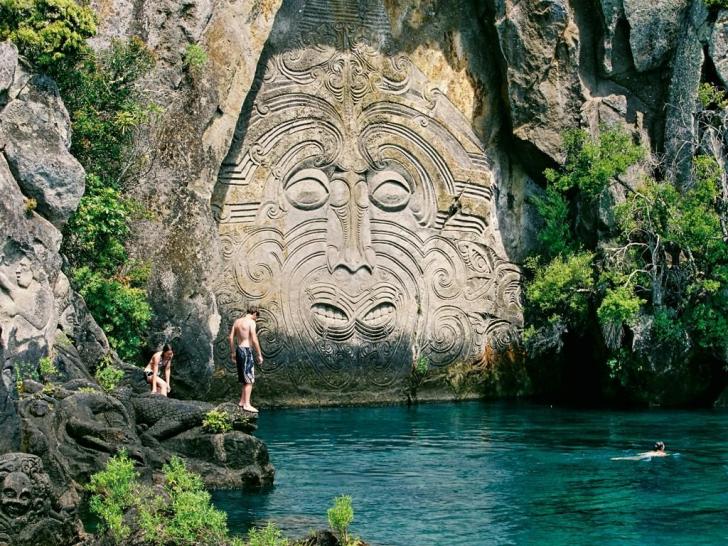 Maori rock carvings at Mine Bay, New Zealand