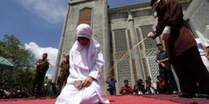 An Indonesian girl being publicly whipped for violating Shari’a law.