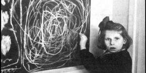 A girl who grew up in a concentration camp draws a picture of ‘Home’ while living in a residence for disturbed children. Poland, 1948.