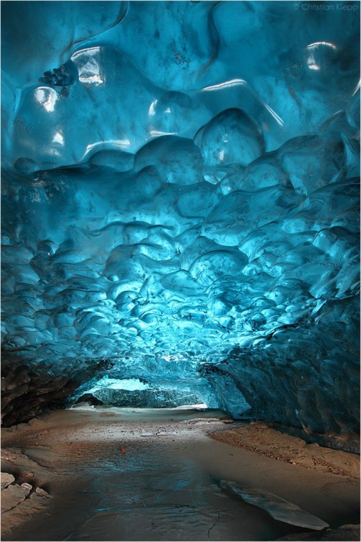 50 meter long Ice Cave on the frozen lagoon of Svinafellsjokull glacier in Skaftafell, Iceland by Christian Klepp