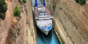 A cruise ship is guided through the Corinth Canal, Greece.