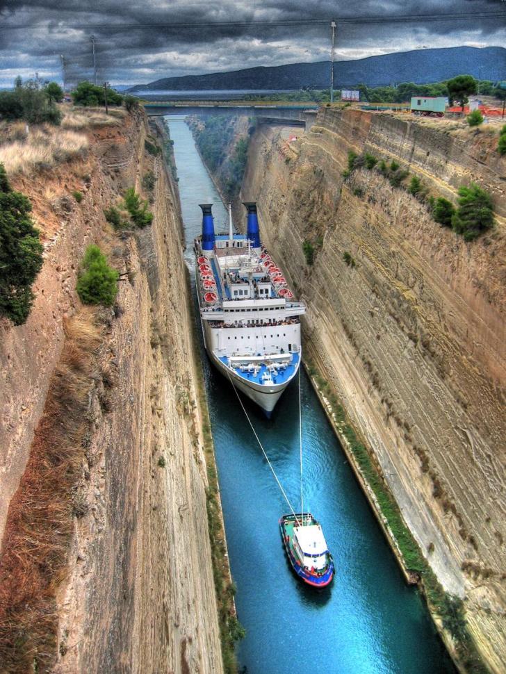 A cruise ship is guided through the Corinth Canal, Greece.