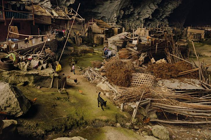 In a giant cave in China, there live 21 families. This cave now contains a basketball court and even a school.