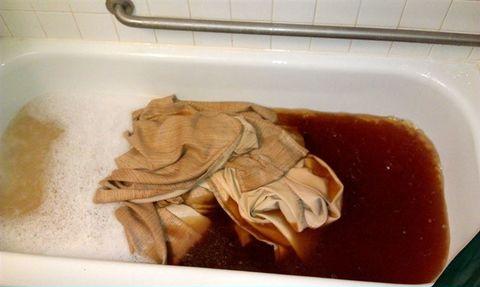 Curtain from the apartment of a smoker after being put in a soap water.