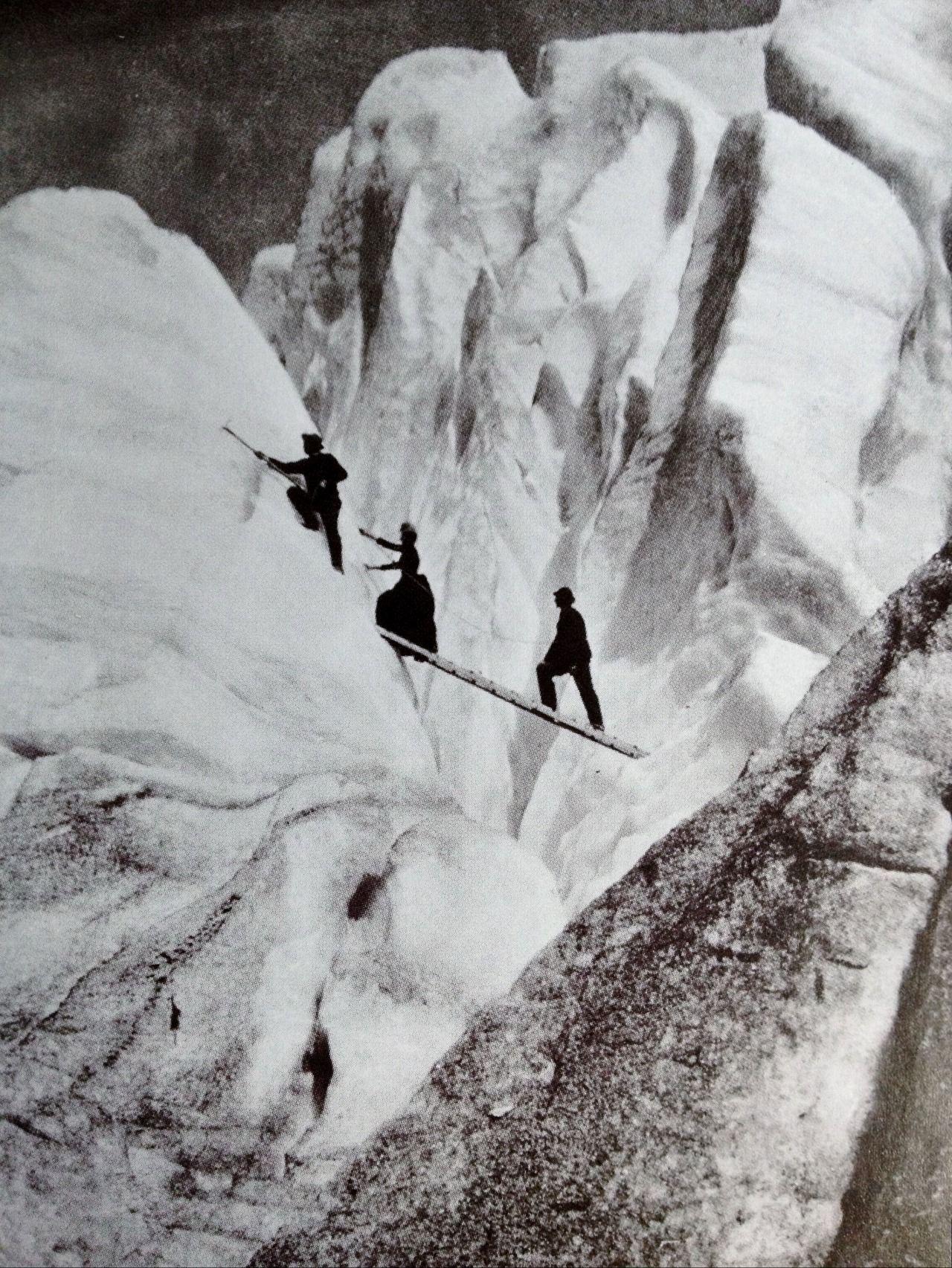 Late Victorian mountaineers cross a crev[ass]e in the Alps, circa 1900.