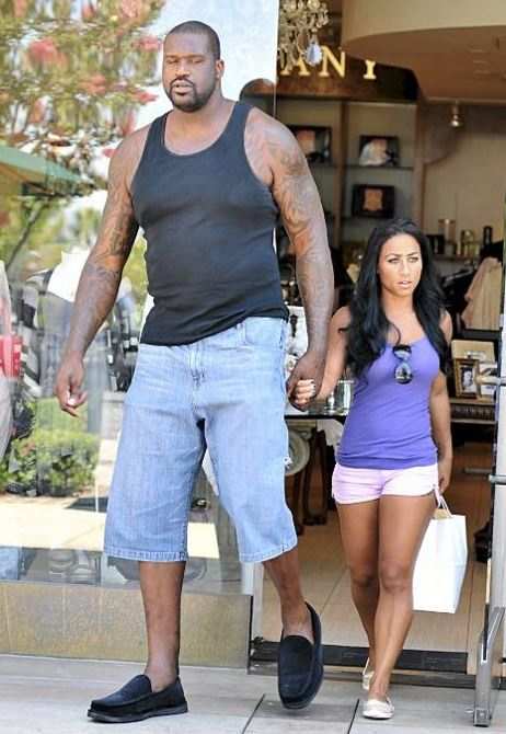 Shaq and his human sized girlfriend.