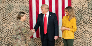 Mr. Trump practices his handhake before meeting with members of the military in Iraq