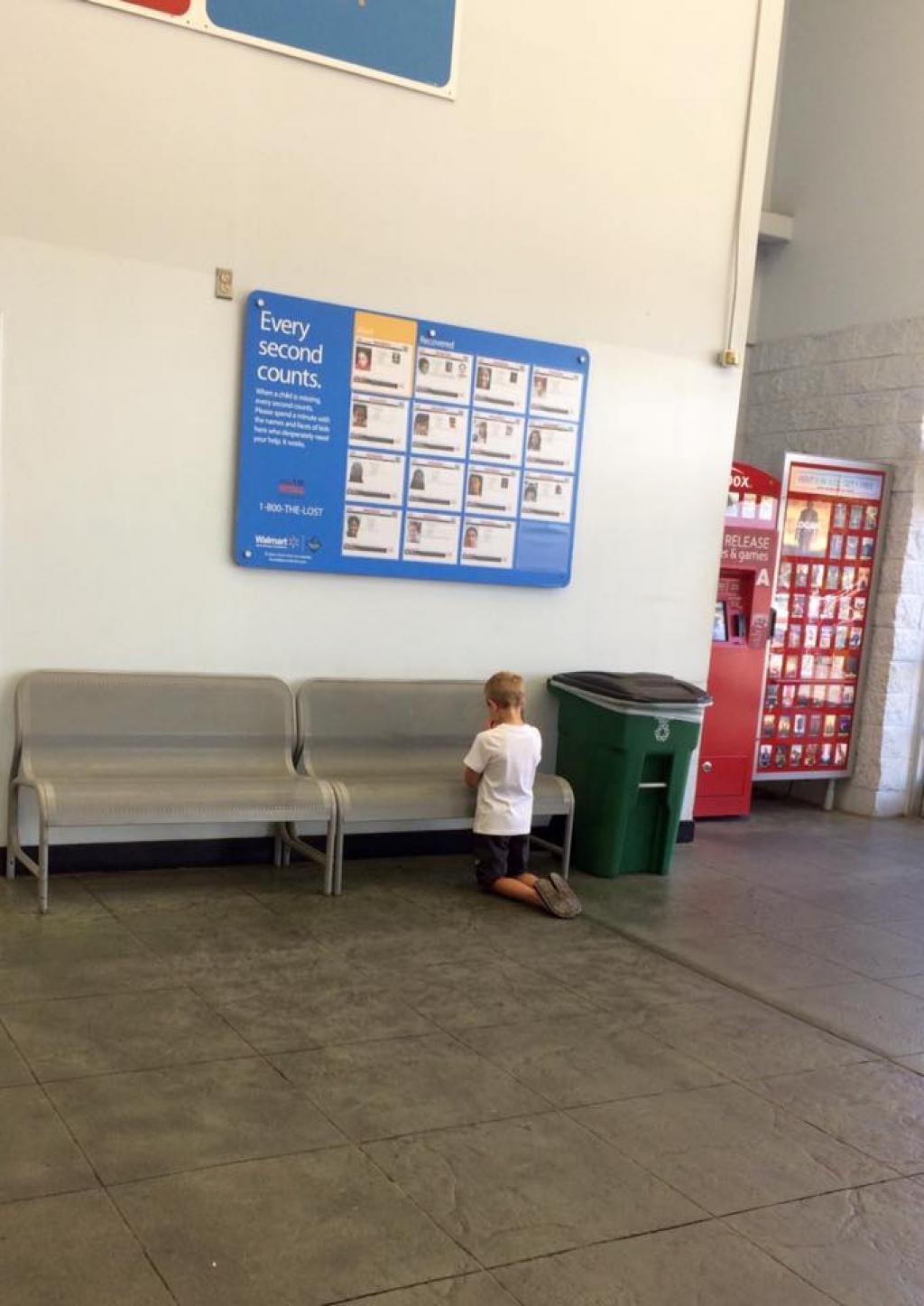 A praryer in front of a missing children sign.