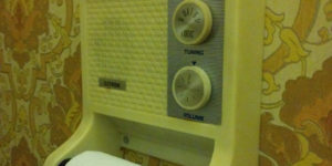 A toilet roll holder with a radio.