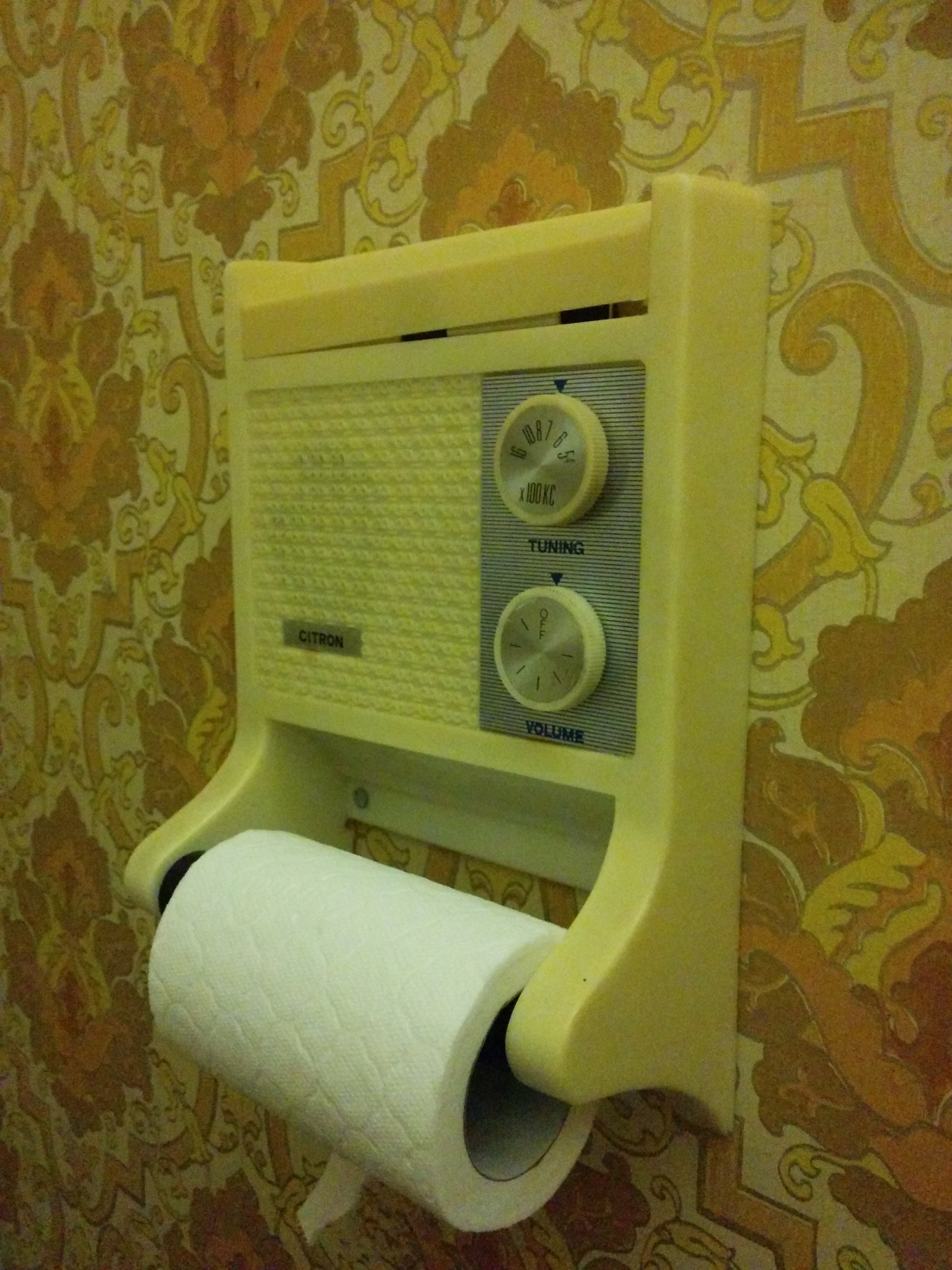 A toilet roll holder with a radio.