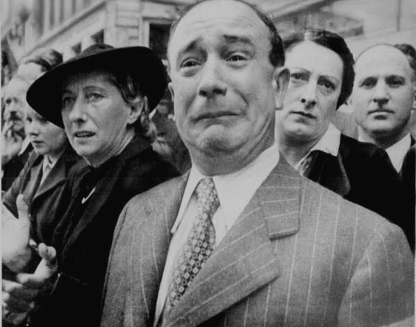 A French civilian cries in despair as Nazis occupy Paris during World War II.