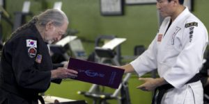 Willie Nelson receiving his fifth-degree black belt in Gong Kwon Yu Sul.