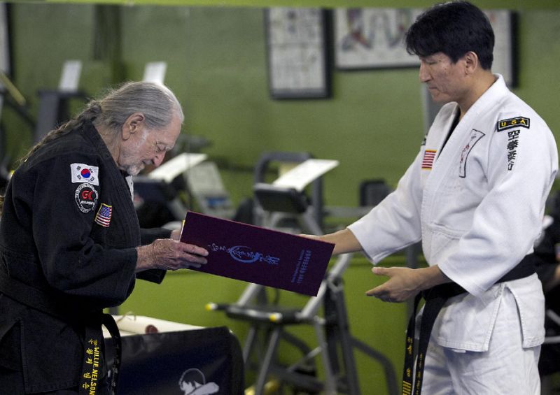 Willie Nelson receiving his fifth-degree black belt in Gong Kwon Yu Sul.