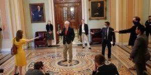 Seven Ministry of Magic wizards trying to cast spells on Mitch McConnell