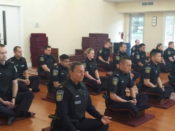 Canadian police officers meditating before they start their day