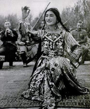 Uighur dancer performing to music, Xinjiang, China, circa 1943.