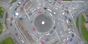 This abomination is The Magic Roundabout, comprised of five smaller roundabouts around a larger one.