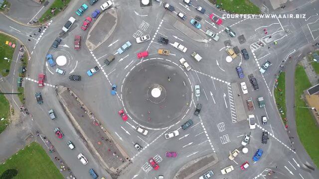 This abomination is The Magic Roundabout, comprised of five smaller roundabouts around a larger one.
