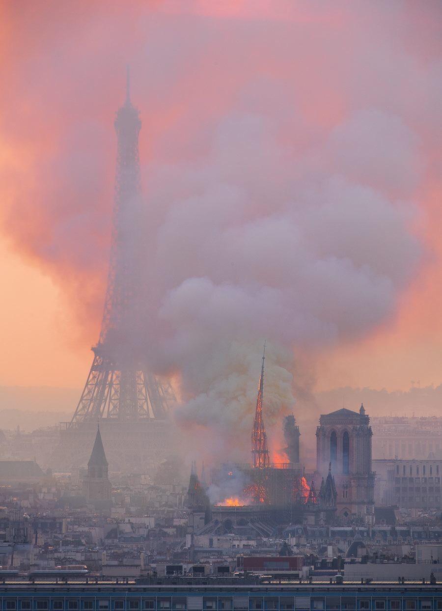 Red was the sky, and hot was the flame, which licked CathÃ©drale de Notre-Dame..