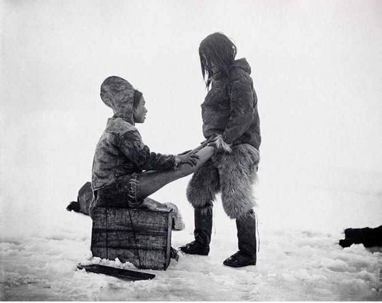 The Inuit man from Greenland warms the wife's feet, circa 1891.