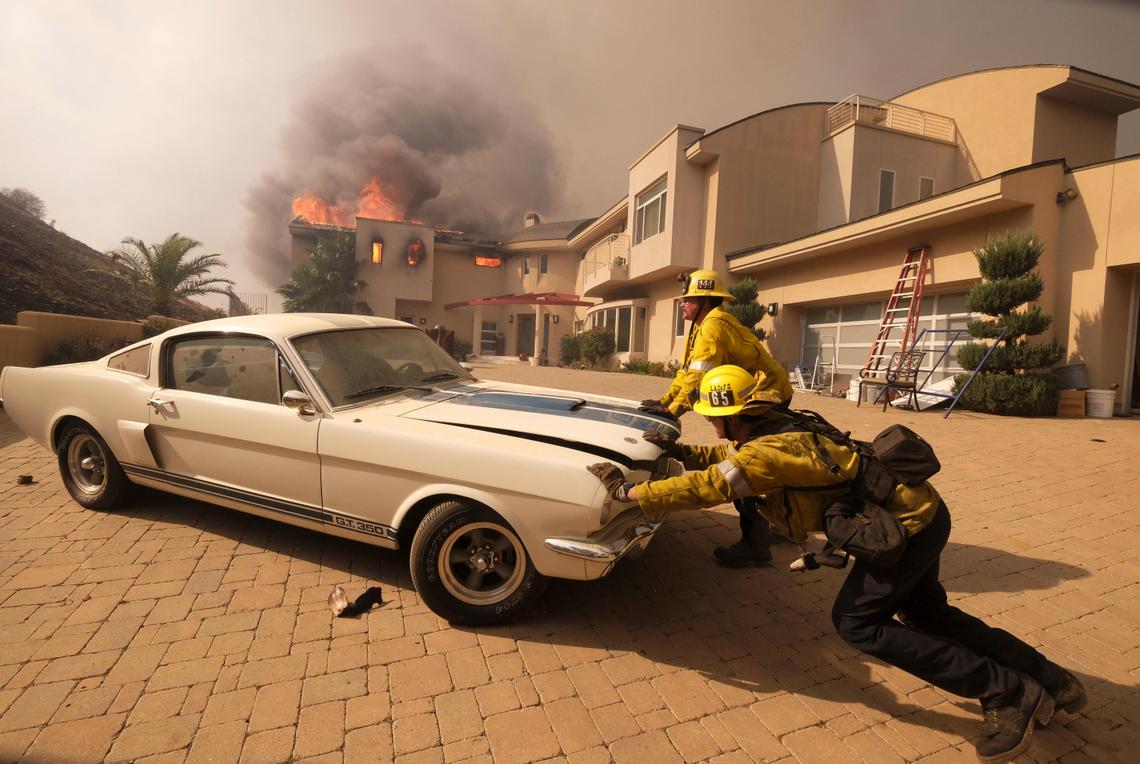 Firefighters saving a classic car from the California wildfires