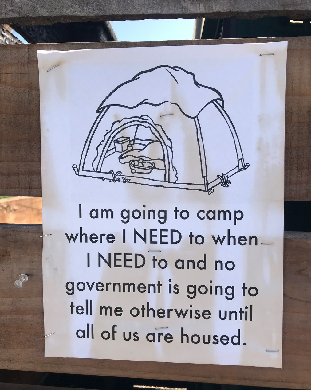 Signs outside a homeless encampment.