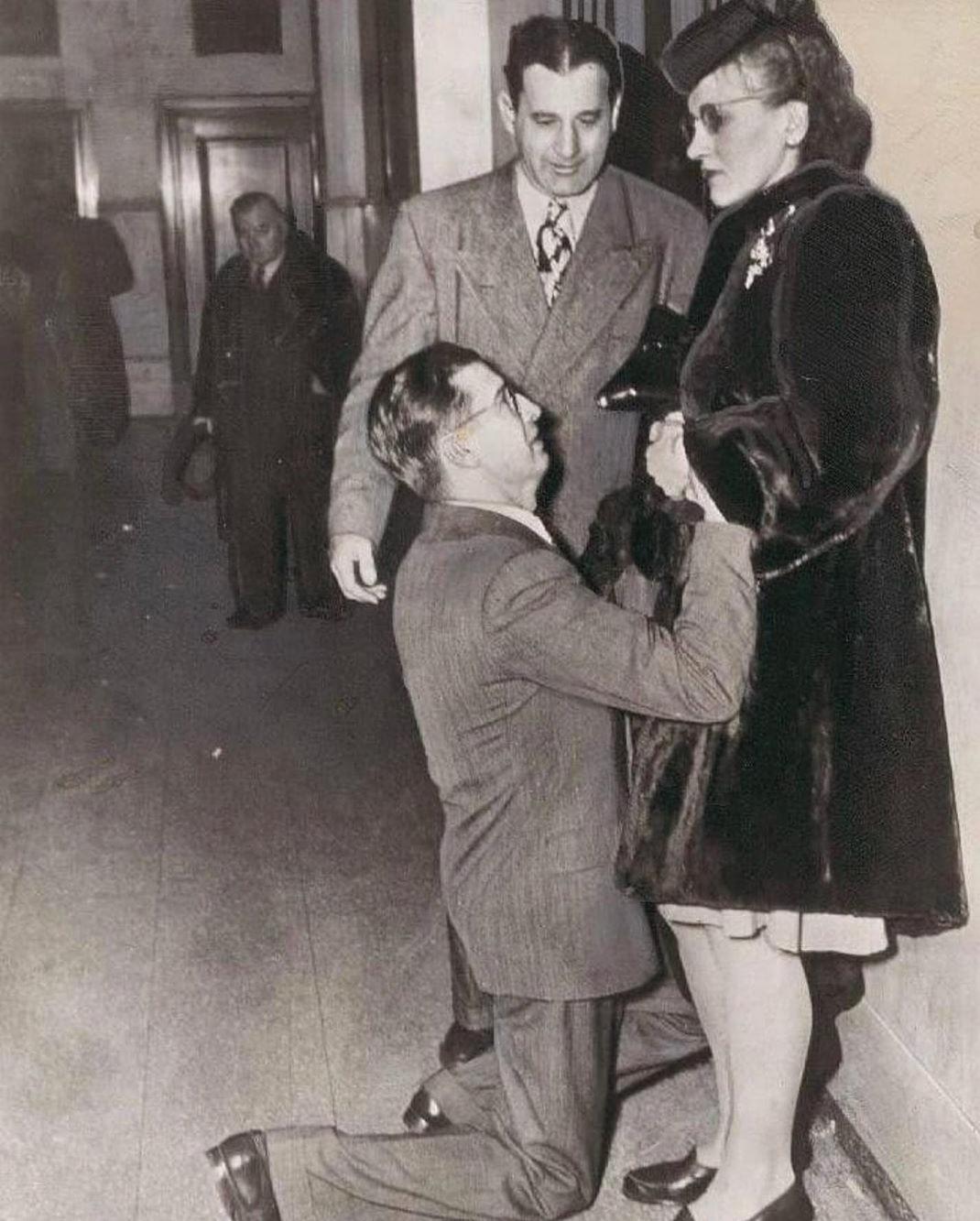 Man begs for her forgiveness outside divorce court, circa 1942.